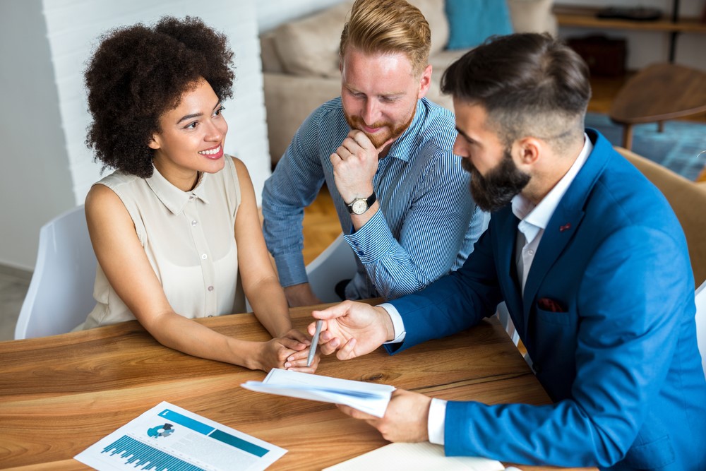 Young,Couple,With,A,Real,Estate,Agent.,Buying,New,House.